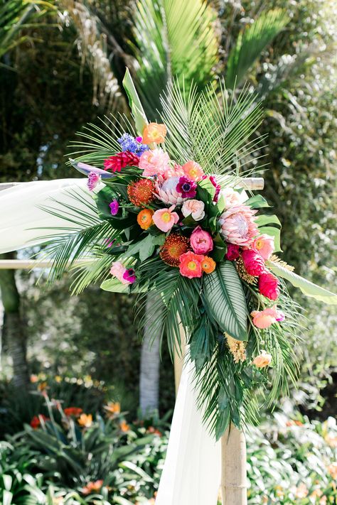 Vibrant King Protea, Ranunculus and Palm Leaf Wedding Arch Arrangement Beach Wedding Arbors, Palm Leaf Wedding, Arch Arrangement, Protea Wedding, Palm Wedding, Beach Wedding Centerpieces, Beach Theme Wedding Invitations, King Protea, Tropical Wedding Flowers