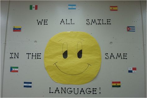 Bulletin board or classroom decoration for foreign language classroom.... Foreign Language Classroom Decorations, We All Smile In The Same Language Bulletin Board, Language Project Ideas, Esl Classroom Decor, Language Classroom Decor, Middle School Esl, Foreign Language Classroom, Spanish Classroom Decor, Classroom Goals