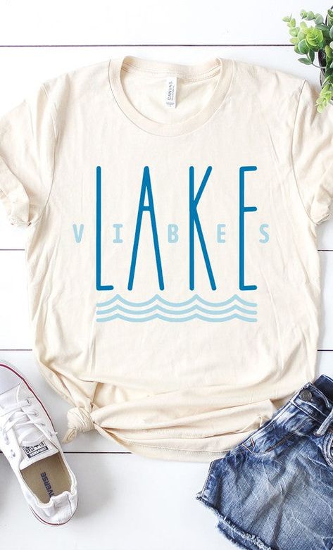 Make a splash with our Lake Vibes Graphic Tee! 💦 Crafted with a lightweight material to keep you comfy and stylish while you enjoy the great outdoors, this trendy tee features a retro design with wavy lines 🌊 and the phrase "Lake Vibes" in bold. Dive right in and show off your love for nature in sizes from S to XL! 🤩 Details: Crew neckline with a relaxed fit Super soft - lived in feel Runs true to size - if you want more of a fitted fit size down. Material and Care 100% Cotton Patterns may va Lake Logos Design, Lake Shirt Ideas, Lake Tshirt Designs, Lake Logo, Lake Shirts, Lake Vibes, Weekend Camping Trip, Funny T Shirt Sayings, Summer Graphic Tee