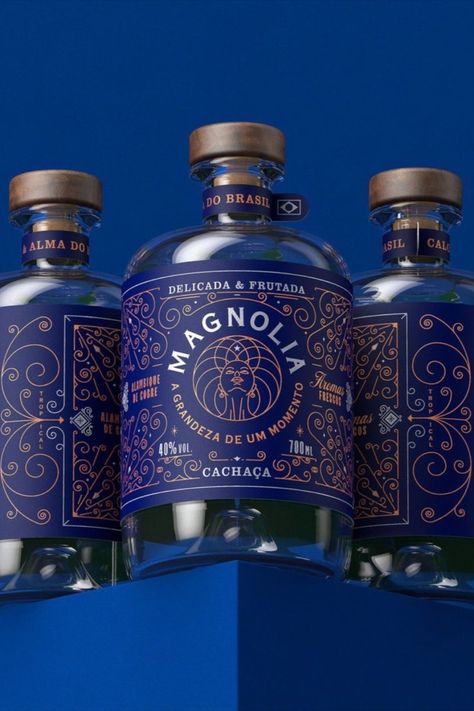 Marcelo Andrade's packaging design for Magnolia Cachaça showcases a rich and stunning dark blue label that effortlessly coordinates with the subtle brown and white details. Drinks Packaging Design, Creative Design Studio, Alcohol Packaging, Gin Bottles, Graphic Design Packaging, Creative Graphic Design, Graphic Design Studio, Beverage Packaging, Graphic Design Studios