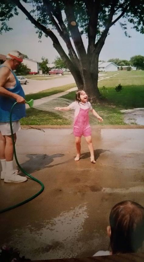 1. This photo, a momento from my childhood, shows me and my grandpa playing with the hose on a hot summer day back in the early 2000s. 2000s Childhood Pictures, Life In The 2000s, Early 2000 Childhood, Early Childhood Aesthetic, 00s Childhood Nostalgia, Summer Childhood Aesthetic, Hot Summer Day Aesthetic, Early 2000s Summer Nostalgia, Childhood Summer Nostalgia