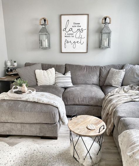 Two gray metal lantern sconces are mounted above a gray sectional sofa with gray throw blankets. A small round wood and black metal cage table is used as a coffee table. Grey Farmhouse Living Room, Modern Farmhouse Living Room Ideas, Grey Sectional Sofa, Modern Farmhouse Living, Grey Sectional, Modern Farmhouse Living Room, Farmhouse Decor Living Room, Living Room Sectional, Decor Home Living Room