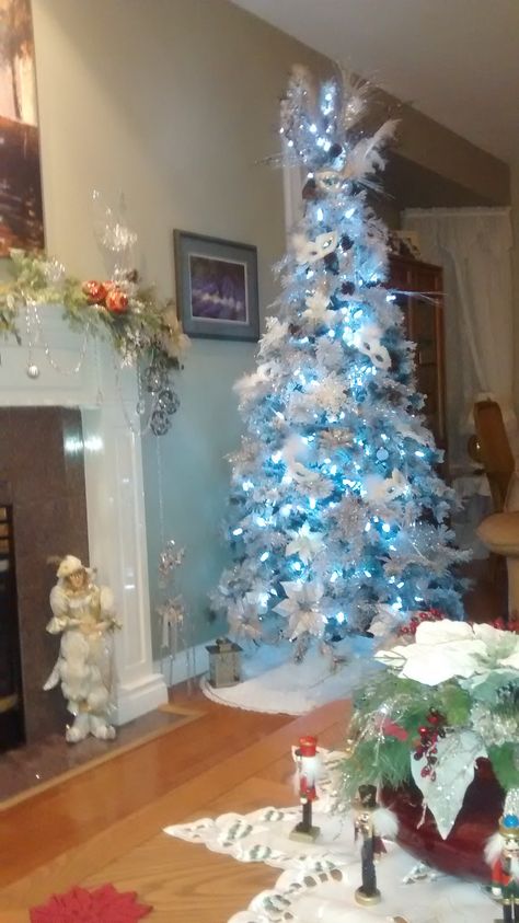 White Tree Blue Lights, Blue Yellow Christmas Tree, White Christmas Tree With Blue Lights, White Christmas Tree Blue Lights, Blue And Yellow Christmas Tree, Christmas Tree With Blue Lights, Blue And Yellow Christmas, Yellow Christmas Tree, Purple Flowering Tree