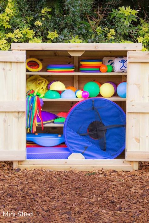 Smart Outdoor Storage solutions for your playground spaces. From loose parts stores to large chests and sheds, tidy your toys away in style, and get back to the real fun!  #OutdoorStorage #OutdoorLearning #StorageSolutions #Education #EducationResources #EarlyYears #EYFS #SchoolStorageSolutions Outside Ball Storage, Outdoor Big Toy Storage, Eyfs Outdoor Storage Ideas, Outstanding Eyfs Outdoor Areas, Early Years Outdoor Storage, Outdoor Storage Solutions, Storage Supplies, Outdoor Learning, Outdoor Kids