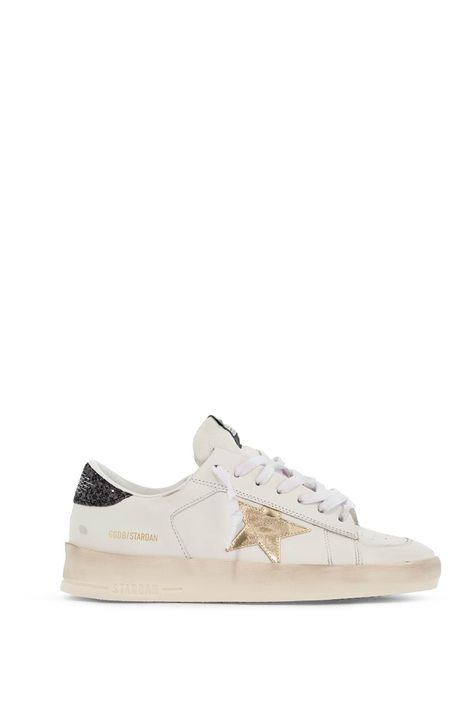 Find GOLDEN GOOSE DELUXE BRAND Stardan Sne on Editorialist. The Golden Goose Stardan sneakers are made of distressed leather and feature the iconic laminated star on the side and a glitter-covered logo spoiler. The GGDB/STARDAN lettering is laminated on the side, with a fabric label featuring the brand's logo on the tongue. The interior is lined with both fabric and leather, and has a removable insole. The rubber sole bears the name of the sneaker on the side. Golden Goose Stardan, The Golden Goose, Running Sneakers Women, Silver Sneakers, Golden Goose Sneakers, Fabric Labels, Golden Goose Deluxe Brand, Latest Sneakers, Crossbody Tote