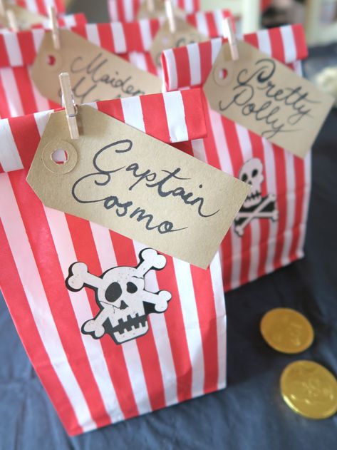 Pirate Party Ideas — Pirate Loot Party Favours — we made pirate 'loot' bags out of red and white striped gift bags secured with a tiny wooden peg. They fit the pirate theme so well and were roomy enough for lots of pirate related gifts. #pirateparty #piratepartyideas Pirate Birthday Party Ideas, Kids Pirate Party, Girl Pirate, Bus Party, Turning Three, Pirate Themed Birthday Party, Boy Cakes, Pirates Party, Pirate Themed Birthday