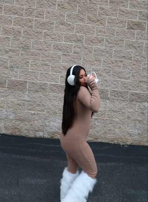 Fashion content creator wearing fashionnova jumpsuit paired with white furry boots and leg warmers. White ear muffs and long black hair. Fuzzy Bucket Hat Outfit Winter, White Ear Muffs Outfit, Ear Muffs Outfit Y2k, Fuzzy Earmuffs Outfit, Earmuffs Outfit Winter, Earmuff Outfits, Winter Headbands Outfit, Winter Headband Outfit, Bucket Hat Outfit Winter