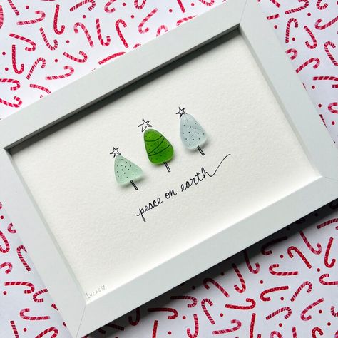 Original sea glass artwork featuring three adorable Christmas trees. Trees are made to order, and the color of the glass will vary. Please choose in the 'personalization section' whether you would like your piece to say, 'Joy to the World' or 'Peace on Earth'. Thank you!

Please note each and every sea glass piece is unique and made to order. 

Presented within a 4"x 6" white frame with glass situated *behind* the watercolor paper due to the sea glass pieces being three dimensional. Sea Glass Christmas Trees, Sea Glass Christmas, Sea Glass Artwork, Holiday Trees, Handmade Wall Decor, Festive Holiday Decor, Glass Artwork, Glass Pieces, Sea Glass Art