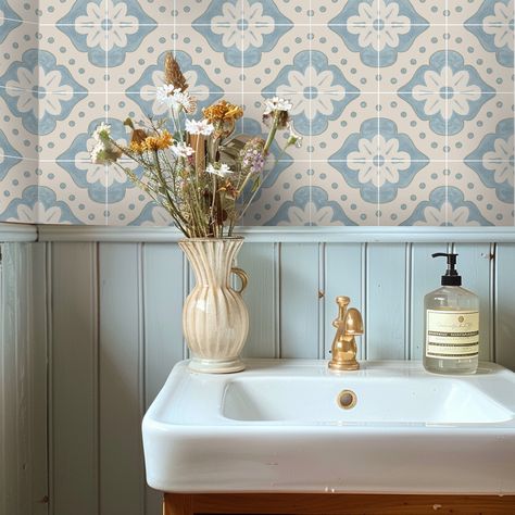 Embellish your home with a touch of modern folk charm with our Larkspur wallpaper in Powder Blue. Embracing the essence of cottage core and French country aesthetics, this design features a captivating dusty blue hue and a delicate floral print. Perfect for the free-spirited decorator, Larkspur brings a fresh, airy vibe to any room. Transform your bathroom with ease and let Larkspur tile stickers add a touch of whimsy to your decor. Explore the beauty of modern folk style and let your space bloom with Larkspur. ColoursThe pattern blends a mix of powder blue & bone white with a hand-painted chalky texture effect. Tile SizeEach tile square is 6" x 6" (15 x 15cm) Farmhouse Wallpaper Blue, Country Cottage Bathroom Tiles, Modern French Country Design, Blue And Cream Bathroom Ideas, Cornflower Blue Bathroom, Botanic Bathroom, Blue Cottage Bathroom, French Blue Bathroom, Bathroom Light Blue