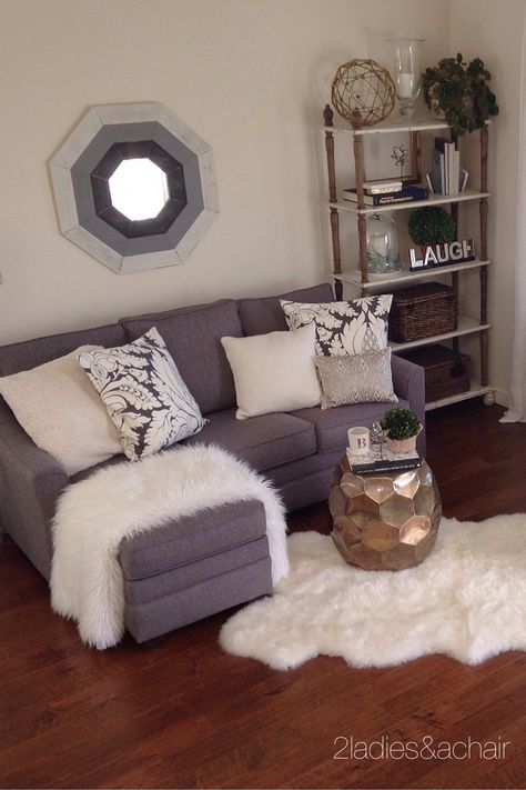 We decorated this space simply with furniture we bought at HomeGoods. The room looks uncluttered and clean in white and gray. This bookcase from HomeGoods is amazing for holding all sorts of big bulky decorating items. The baskets are filled with all sorts of decorating knicknacks to use at another time, so this bookcase doubles nicely as a storage/display area. I don't think anyone would guess that it's acting as a storage closet! Sponsored by HomeGoods Small Flats, Small Room Sofa, Small Sectional Sofa, Interior Design Minimalist, Real Estat, Small Apartment Living Room, Small Apartment Decorating, Small Apartment Living, Small Room Design