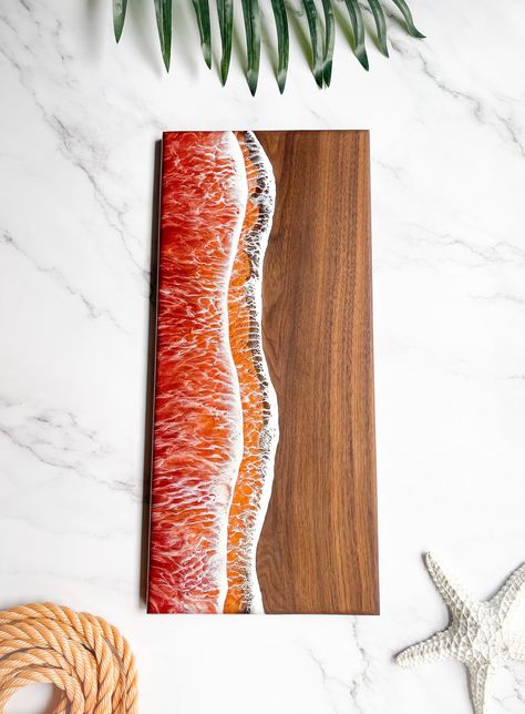 These Charcuterie boards are perfect for the beach lover, they are the perfect way to bring that zin and all the fall vibes to the table whether you're serving breakfast, lunch, or even a snack! They are made from a Walnut slab purchased locally, 100% made from scratch! There are two layers of ombre waves starting with a copper orange into a rich red- the depth you will see in these layers are so unreal yet realistic!  For personalization please pick from the drop down (There is a photo with the Beach House Kitchens, Breakfast Tray, Cheese Tray, Resin Pour, Resin Ideas, Made From Scratch, Beach Lover, Charcuterie Boards, Beach Lovers