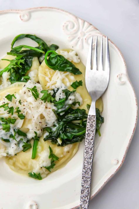 This vegan pierogies recipe with spinach is one of my family's favorite quick and easy meals! Potato and onion perogies served in a bed of spinach sauteed in garlic butter and topped with melty vegan cheese, it tastes like it's from a fancy restaurant but only takes about 15 minutes to make. Vegan Perogies, Meals Potato, Spinach Sauteed, Pierogies Recipe, Recipe With Spinach, Perogies Recipe, Vegan Pasta Sauce, Pierogi Recipe, Cooking Vegan