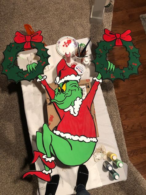 Grinch with wreaths Grinch Swinging On Wreaths, Grinch Hanging From Wreath, Diy Grinch Wall Decor, Mount Crumpit Grinch Diy, Grinch Outdoor Decorations, Diy Whoville Decorations, Whoville Wreath, Grinch Outdoor Christmas Decorations, Grinch Christmas Decorations Diy