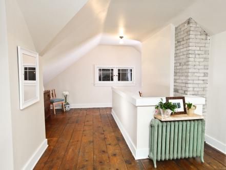 STAIRWELL,+AFTER:+The+pine+floorboards+were+sanded+and+heavily+coated+with+three+layers+of+polyurethane.+New+casings+were+built+around+the+windows+but+their+style+looks+old+and+fits+the+house's+charm. 1920s Bungalow Remodel, Green Radiator, Pine Floorboards, 1920s Home Renovation, Unfinished Attic, Chicago Bungalow, Rehab Addict, 1920s Bungalow, Bungalow Interiors