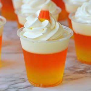 Candy Corn Jello Shots - Balancing Motherhood Candy Corn Jello, Candy Corn Desserts, Candy Corn Jello Shots, Halloween Jello Shots, Halloween Jello, Fun Halloween Treats, Jello Shot Recipes, Fun Halloween Food, Halloween Treats Easy