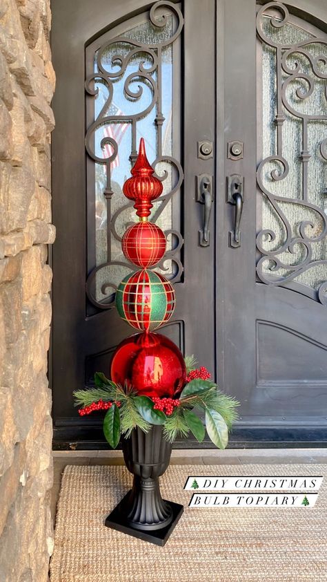 diyfrenchfarmhouse on Instagram: ❤️💚So many things are flying off of the shelves this year...I wanted to share this DIY Christmas Bulb Topiary with you all while the… Ornament Topiary Diy Front Doors, Christmas Ball Topiary Ornament Tree, Christmas Ball Topiary Diy, How To Make Christmas Topiary, Topiary Christmas Tree, Christmas Finials Diy, Christmas Topiary Outdoor Diy, Christmas Ornament Topiary Diy, Diy Christmas Topiary Front Doors