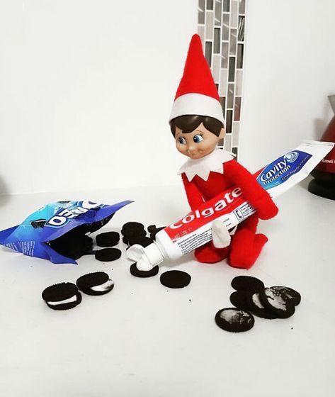 "Elf On The Shelf idea with an elf mischievously replacing Oreo cream filling with toothpaste, creating a prank setup with scattered cookies." Elf On The Shelf Marker On Face, Food Elf On The Shelf Ideas, Elf Oreo Toothpaste, Oreo Elf On The Shelf, M&m Elf On The Shelf, Skittles Elf On The Shelf, Elf On The Shelf Treat Ideas, Elf On The Shelf M&ms, Elf On The Shelf Cereal Spill Prank