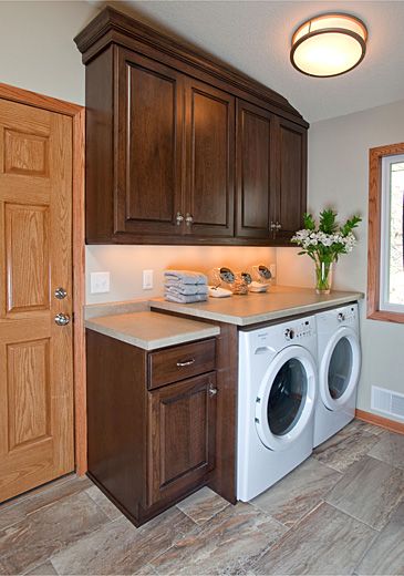 stone-laundry-room-after1 Crystal Kitchen, Crystal Cabinets, Mudroom Cabinets, Compact Laundry, Laundry Space, Laundry Cabinets, Brown Cabinets, Laundry Room Cabinets, Cherry Cabinets