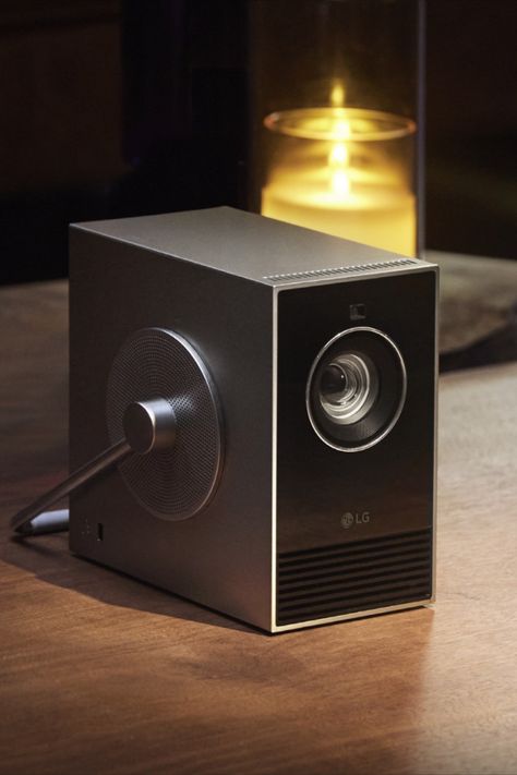 The Artistic LG CineBeam Qube 4K Projector Comes With 360-Degree Swivel Handle Lg Cinebeam, Backyard Living Room, 2025 Trends, Perfect Movie, Computer Camera, Electronic Musical Instruments, Portable Projector, Environment Day, Video Projector