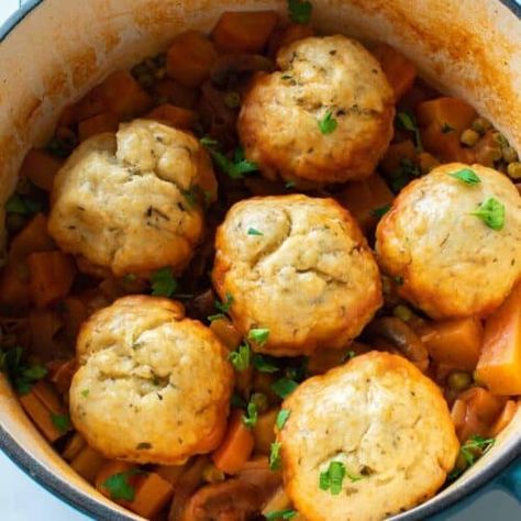 This delicious vegetable stew with dumplings is an easy vegan stew packed with root vegetables, homemade dumplings and more. Perfect fall dinner with parsnips, swede, carrots, peas, mushrooms and a tomato based broth. This hearty root vegetable casserole is so easy to make, and a great way to use up leftover vegetables, or a surplus of seasonal veg from your garden. The stew stores really well too! Stew Dumplings Recipe, Shrimp Tofu Recipe, Stew Dumplings, Thick Beef Stew, Stew With Dumplings, Quick Pickled Radishes, Sweet Potato Recipes Mashed, Easy Dumplings, Campbells Soup Recipes