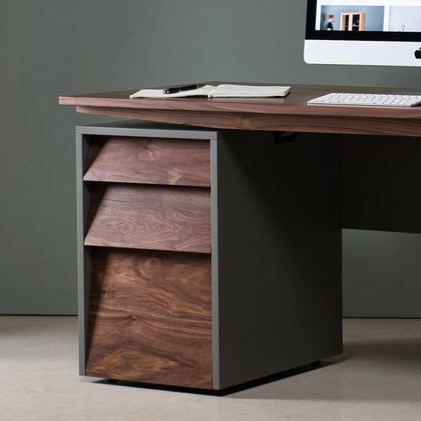 This ergonomic height adjustable sit-stand walnut desk is an elegant reimagination of a traditional writing desk. The walnut desk transforms from seating to standing at the touch of a button. A central sit-stand mechanism allows for the tabletop to smoothly rise and fall, controlled by a touch screen console. This walnut design is defined by statement bold lines and sleek angles. Exhibiting expert craftsmanship, the sit-stand desk is beautifully handmade from solid American Black Walnut. Boastin Sit Stand Desk Top, Live Edge Sit Stand Desk, Black Wooden Desk, Desk Setup Wood, Table Desk Ideas, Mens Office Desk, Wooden Desk Design, Custom Desks, Walnut Office Desk