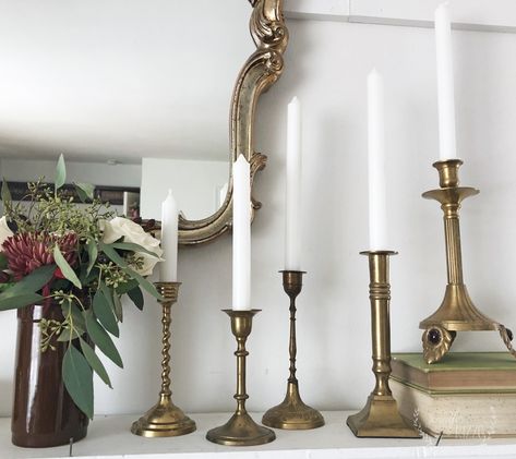 Vintage brass candlesticks on a mantel Styling Brass Candlesticks, Brass Candlesticks On Mantle, Brass Candlesticks Decor, Fireplace Mantel Makeover, Candle Stick Centerpiece Brass, Vintage Brass Candlesticks Decor, Brass Cabdlesticks, Vintage Brass Decor, Candlestick Lamps