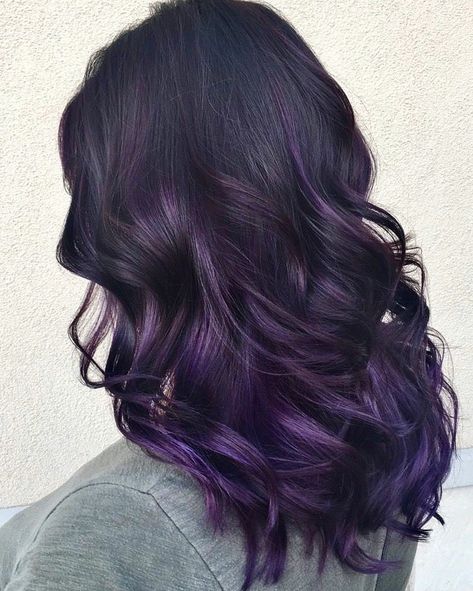 There is something about purple hair that just looks stunning. The color has an array of different hues and can easily work on any hair type and skin ... Purple Hair Lowlights, Dark Purple Underdye Hair, Dark Roots Purple Hair Balayage, Fun Dyed Hair For Brunettes, Dark Purple Balayage Brunettes, Black Roots Purple Hair, Purple Hair With Dark Roots, Purple Underdye Hair, Low Maintenance Hair Color For Dark Hair