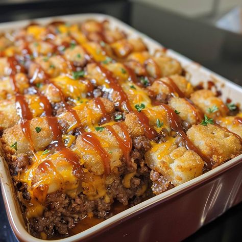 🧀🍴 Dive into comfort food heaven with Cheesy Tater Tot Meatloaf Casserole! #ComfortFood #TaterTotCasserole 🍽️ Cheesy Tater Tot Meatloaf Casserole 🛒 Ingredients: 500 grams ground beef 200 grams tater tots 100 grams cheddar cheese, shredded 1 onion, finely chopped 2 cloves garlic, minced 100 ml ketchup 50 ml Worcestershire sauce 1 egg Salt and pepper to taste 👩‍🍳 Instructions: Preheat Oven: Preheat to 180°C (350°F). Mix Ingredients: Combine ground beef, onion, garlic, ketchup, Worcestershir... Tater Tot Meatloaf, Cheesy Tots, Savory Meatloaf, Meatloaf Casserole, Fall Party Food, Tater Tots, Yummy Comfort Food, Exotic Food, Food Heaven