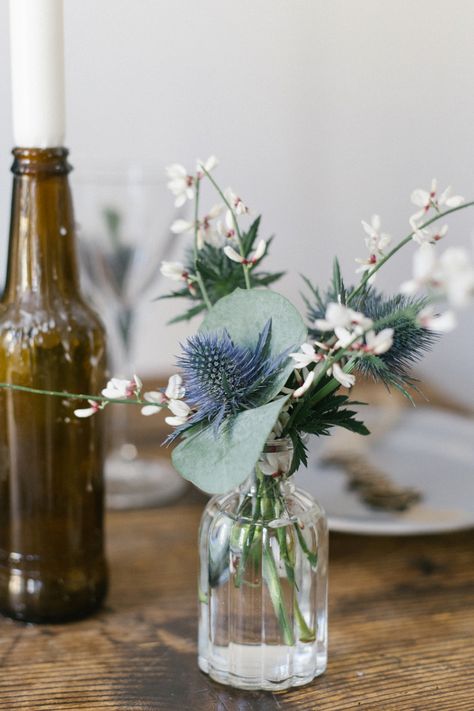 Little Vases With Flowers Wedding, Mini Vase Wedding Decor, Blue Thistle Wedding Centerpieces, Flowers In Bottles Wedding, Bud Vases Purple Flowers, Simple Table Centerpieces, Simple Wedding Table, Blue Delphinium Bud Vase, Thistle Wedding