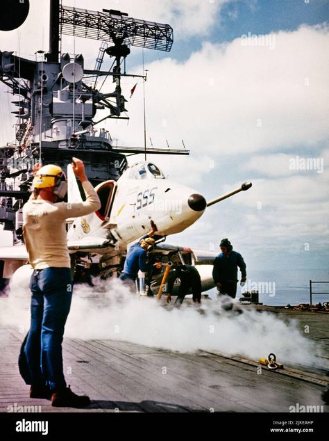 Download this stock image: 1960s 1970s CREWMAN ABOARD ATTACK AIRCRAFT CARRIER USS HANCOCK GUIDES A4 SKYHAWK JET OPERATING IN SOUTH CHINA SEAS VIETNAM WAR - km1356 HAR001 HARS ATTACK TRANSPORTATION SEAS SKILL OCCUPATION SKILLS OPERATING ADVENTURE AIRPLANES JET NAVAL COURAGE EXCITEMENT EXTERIOR LOW ANGLE POWERFUL AVIATION OCCUPATIONS UNIFORMS FORCES CONCEPTUAL GUIDES NAVIES SUPPORT USN COOPERATION MID-ADULT MID-ADULT MAN SKYHAWK YOUNG ADULT MAN ABOARD HAR001 LAUNCHING OLD FASHIONED - 2JKEAHP from Flying Aircraft Carrier, Chinese Aircraft Carrier, Uss Hancock, A4 Skyhawk, Uss Ranger Cv-61, Us Navy Aircraft, Low Angle, South China, South China Sea