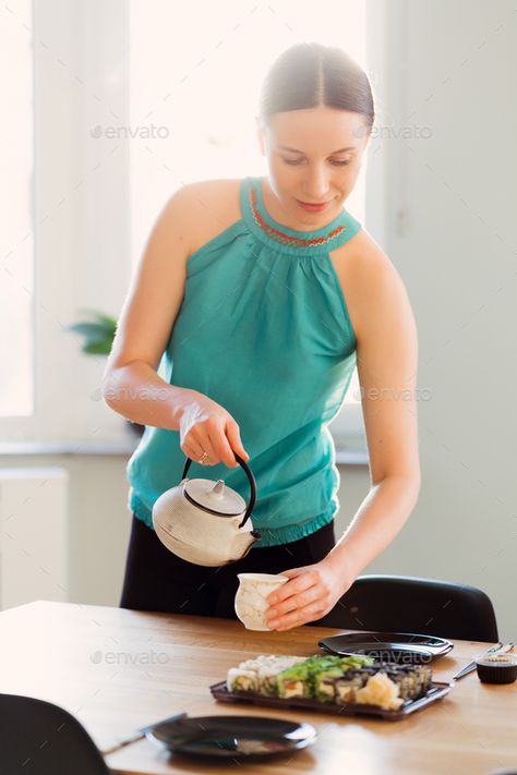 A lovely woman with a teapot in her hands pouring tea by arthurhidden. Smiling woman pouring tea while waiting her friends for a sushi party in a sunny living room #Sponsored #pouring, #tea, #arthurhidden, #hands Sipping Tea Reference, Pouring Tea Reference, Person Pouring Tea, Tea Pouring Drawing, Tea Pot Pouring Into Tea Cup, Woman Pouring Tea, Mermay 2024, Sunny Living Room, Pouring Tea