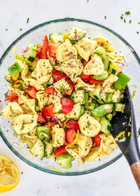 This Zesty Italian Tortellini Pasta Salad is packed with bell peppers, cucumber, pepperoncinis, and cheese tortellini tossed in a simple lemon Italian dressing. Everyone will enjoy this crisp and easy make-ahead friendly cold pasta salad! ProjectMealPlan.com Cold Tortellini Pasta Salad Simple, Italian Tortellini Pasta Salad, Italian Tortellini Pasta, Cheese Tortellini Salad, Italian Tortellini, Tortellini Pasta Salad, Fresh Pasta Recipes, Pasta Salad With Tortellini, Best Macaroni Salad