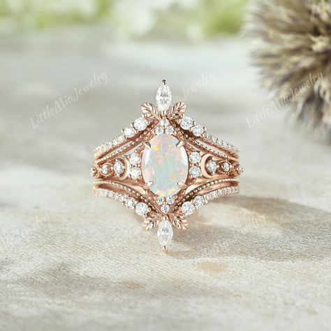 Unique Moon Design Opal Engagement Ring Set Rose Gold Ring Enhancer Moissanite Double Curved Wedding Band Fire Opal Ring Set Bridal Ring Set ◆RING DETAILS: ❃Engagement ring: Centre Stone: Stone: Opal Shape: Oval cut  Size: 6x8mm Side Stone: Moissanite Shape: Round cut Weight: 0.182ct ❃Band Width:1.5mm ❃Wedding band: Stone: Moissanite Shape: Round cut and Pear Cut Weight: About 0.403ct Band Width: 5.0mm ◆All ring sizes are available, If you can't find your ring size in the list, please feel free Opal Wedding Ring Set Rose Gold, Engagement Rings With Opal, Gold Ring Enhancer, Opal Wedding Ring Set, Fire Opal Engagement Ring, Western Rings, Opal Engagement Ring Set, Opal Wedding Band, Hand Jewellery