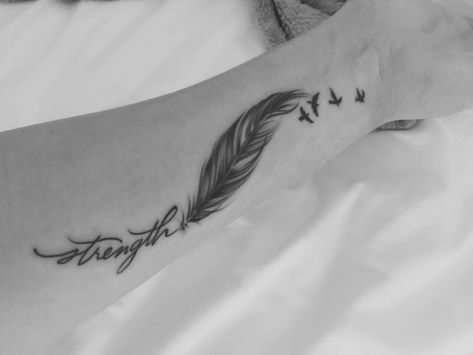 Wrist tattoo strength, feather, 4 birds Feather And Birds Tattoo Ideas, Feather With Words Tattoo, Feather Word Tattoo, Breathe Feather Tattoo, Feather Wrist Tattoo, Feather Tattoos With Quotes, Feather Bible Verse Tattoo, Feather Quote Tattoo, Just Breathe Feather Tattoo