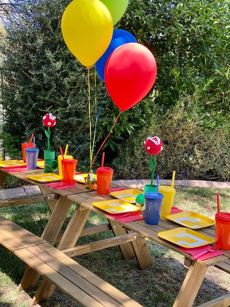 The kids table had mystery block plates and pirahana plants! #supermariobros #supermarioparty #kidstables #marioparty Mario Birthday Table Decor, Super Mario Cake Table, Super Mario Table Set Up, Super Mario Dinner Party, Rainbow Road Mario Kart Party, Mario Birthday Party Dollar Tree, Super Mario Bros Party Supplies, Super Mario Cake, Super Mario Bros Party