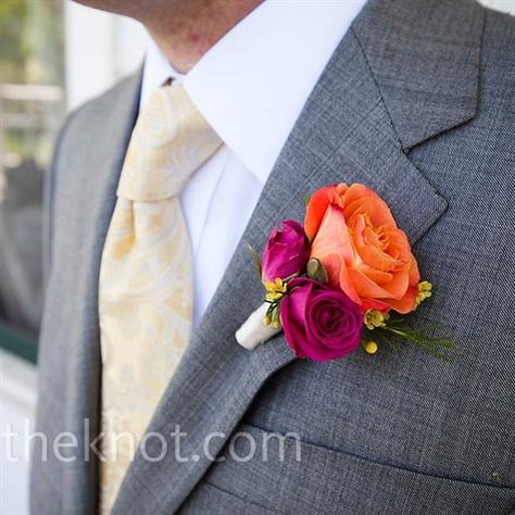 In keeping with the color scheme, a cluster of orange and pink roses and yellow wax flowers decorated Christian‘s lapel and worked well with his soft yellow tie. Pink And Orange Centerpieces, Orange Boutonniere, Orange Centerpieces, Old Fashioned Wedding, Pink Boutonniere, Orange And Pink Wedding, Wax Flower, Groomsmen Boutonniere, Rose Boutonniere