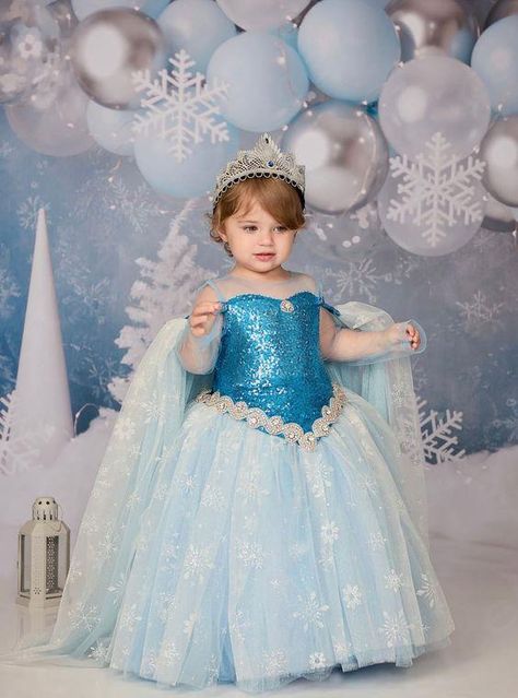 This beautiful slightly below the knee dress is made with extremely soft glittery tulle and lined from top to bottom with cotton perfect for baby and children sensitive skin. Each dress comes with a matching headband and a cape. Pre-Order: Ships in 3-4 weeks. Need Something Different Or Different Color? WhatsApp: 16314885153 Call: 1(888) 381-3742 This dress can be custom made up to age 12 years. ... daha fazla Elsa Birthday Dress, Elsa Dress For Kids, Event Clothes, Below The Knee Dress, Frocks For Kids, Princess Birthday Party Decorations, Frozen Birthday Theme, Frozen Dress, Angel Kids