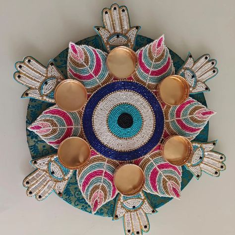 Evil eye Rangoli with hamza on the mdf base of 10"  DM us for more details or WhatsApp us on 9867422790 Arti Decoration, Mud Mirror Art, Diwali Crafts, Quilling For Beginners, Handmade Rakhi Designs, Diya Rangoli, Diwali Gift Hampers, Pooja Decoration, Paper Quilling For Beginners