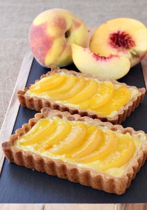 This Peach Custard Tart recipe is an easy way to use up fresh or frozen fruit and is prefect with your morning coffee or as an after dinner dessert! #custard #tart #peaches #dessertrecipes Peach Custard, Peach Tart Recipes, Custard Tarts Recipe, Easy Tart Recipes, Easy Custard, Peach Tart, Custard Tart, Pastry Tart, Peach Recipe