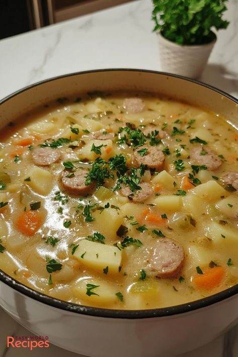 German Potato Soup, or Kartoffelsuppe, is the ultimate comfort food! Creamy potatoes, smoky sausage, and a mix of root vegetables come together in a hearty soup that warms you from the inside out. Paired with crusty bread, this potato soup is as satisfying as it is simple to make. German Sausage And Potato Soup, Best Potatoes For Soup, German Potato Soup With Sausage, German Soup Recipes, Bratwurst Soup, Potato Soup With Sausage, Cabbage And Potato Soup, German Soup, German Potato Soup