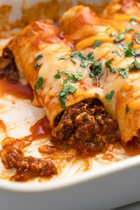 This easy ground beef enchiladas recipe takes simple ingredients and transforms them into delicious enchiladas smothered in sauce and cheese. Ground Beef Enchiladas With Red Sauce, Meat Enchiladas, Beef Enchiladas With Red Sauce, Easy Ground Beef Enchiladas, Mexican Board, Mexican Ground Beef Casserole, Beef Enchiladas Recipe, Enchiladas Recipes, Mexican Dinners