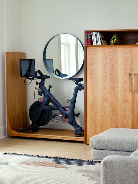 Peloton And Office Room, Guest Room Peloton, Living Room With Peloton, Bedroom With Exercise Equipment, Living Room Exercise Space, Peloton In Small Apartment, Hidden Gym Equipment Storage, Peloton Storage Ideas, Hide Peloton Bike