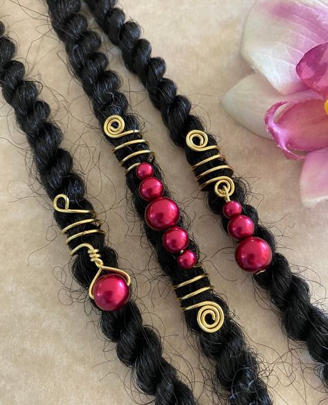 This is a set of 3 gold coil/spiral loc, dreadlock, twists, or braid charms. Each is adorned with red glass pearls intertwined into or dangling from the coil. Opening/hole in coils as shown is 8mm. Made with 20g tarnish resistant gold wire. Also available with silver wire. Please add a note to seller if you would like silver wire. *If you need a different size (other than 8mm as shown), please add a note to seller at checkout with the size needed. All items are lead and nickel free. Diy Loc Jewelry, Loc Charms, Braid Charms, Hair Jewelry For Braids, Wrapping Stones, Hair Locs, Dread Jewelry, Dread Accessories, Dreadlock Jewelry