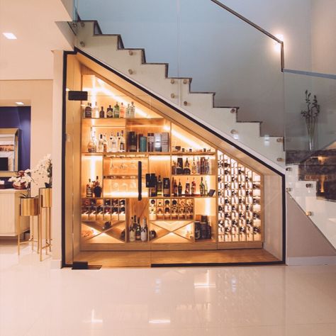 bar under the stairs , with a efficient use of space and an eye catching modern design . Understairs Bar Ideas Modern, Under Stairs Alcohol Storage, Basement Stair Well Wall Ideas, Stair Case Banister, Understair Wine Cellar Staircases, Unique Custom Home Features, Under Stair Wine Cellar, Understairs Bar Ideas, Wine Under Stairs