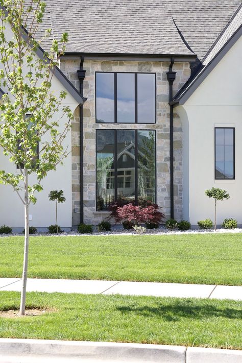 Modern Tudor House Exterior, Utah Parade Of Homes, Tudor Exterior, Tudor House Exterior, Painted Brick Walls, Stone Fireplace Surround, Open Family Room, Popular Paint Colors, English Tudor