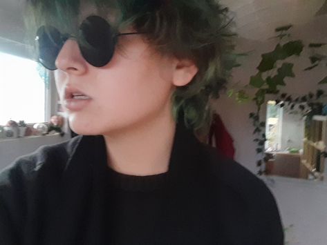 Green hair, dark green hair, black glasses, round glasses, hair, hair inspiration, short green hair, gender fluid, crowley glasses Crowley Glasses, Hair Ideas Dark, Green Hair Short, Short Green Hair, Queer Hair, All Black Fit, Dark Green Hair, Gender Fluid, Black Glasses