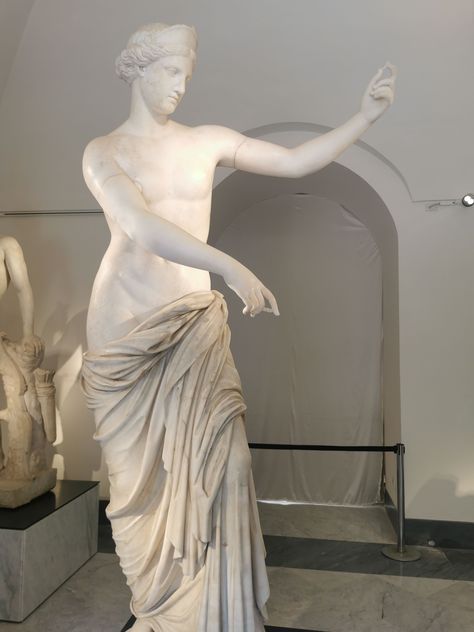 This marble statue likely represents Aphrodite, the goddess of love and beauty, captured in a graceful and flowing form. The serene expression and elegant pose, with the figure draped in fabric, emphasize the classical depiction of the deity. The statue conveys a moment of gentle movement, possibly symbolizing a narrative or action associated with Aphrodite. 

#GreekGods #Mythology #GreekMythology #OlympianGods #olympioi #AncientGods #AncientGreece #Olympians #Titans #Olympioi Aphrodite Aesthetic Statue, Greek Statue Poses, Odysseus Statue, Aphrodite Statues, Aphrodite Mythology, Aphrodite And Ares, Aphrodite Sculpture, Aphrodite Greek Goddess, Aphrodite Statue