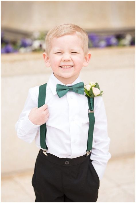 Ring bearer cheesy smile at the camera with emerald green suspenders and bowtie | Ogden Temple Winter Wedding | Emerald Green and Pink Wedding | Jessie and Dallin Photography Emerald Ring Bearer, Ring Bearer Emerald Green, Black Tux Emerald Green Tie, Emerald Green Black White Silver Wedding, Forest Green Ring Bearer Outfit, Emerald Quinceanera Centerpieces, Emareld Green Wedding Theme, Winter Emerald Green Wedding, Ringbearer Cute Ideas