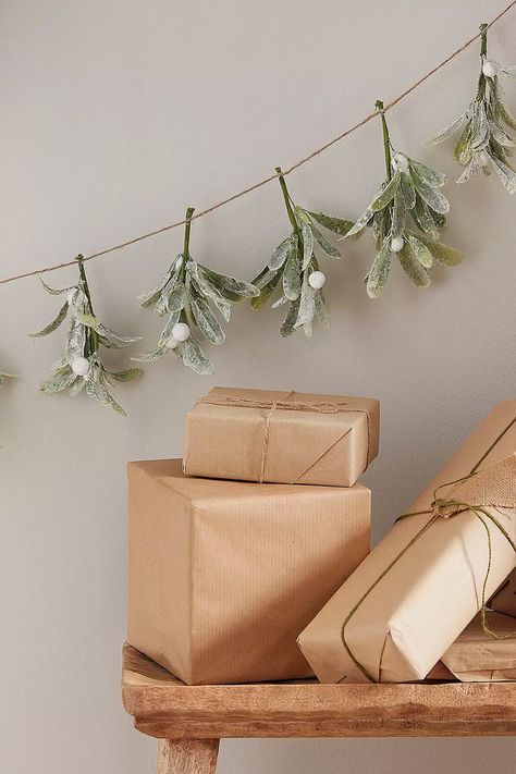 Bring the festive spirit into your home and get ready for plenty of kisses with this mistletoe garland. Faux mistletoe is topped with snow-inspired dusting and hung together with natural string. Mistletoe Garland, Kiss Under The Mistletoe, Christmas Setup, Foliage Garland, Farmhouse Christmas Stockings, Christmas Foliage, Mistletoe Christmas, Neutral Christmas Decor, Ginger Ray