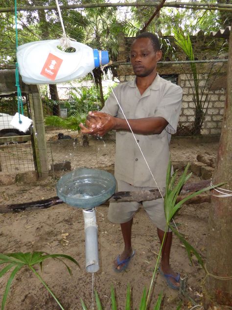 Our tippy tap for hand washing.  The foot pedal manipulates the plastic bottle above which tips out water onto the users hands. Functional Anti-odor Socks For Outdoor Activities, Camping Hand Washing Station, Tippy Tap, Plastic Bottle Ecosystem, Water And Sanitation, Water Purification, Plastic Bottle, Clean Water, Plastic Bottles